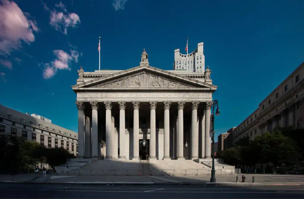 Neoclassical courthouse with tall columns and American flag